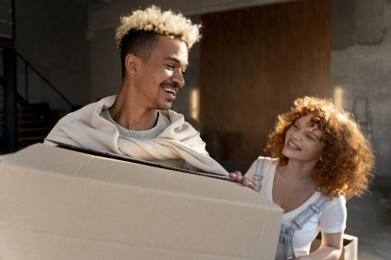 Moving Back Home with Your Parents – couple moving cardboard boxes