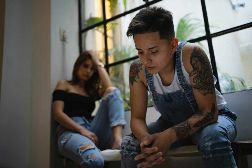 Lesbian couple looking upset after having an argument at home. LGBTQ Couples Therapy in Melbourne – Safe Place Therapy